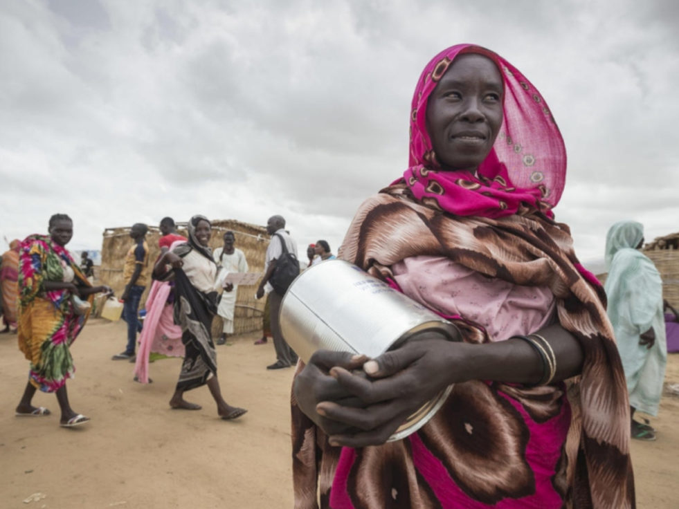 Refugee in Sudan holding pot