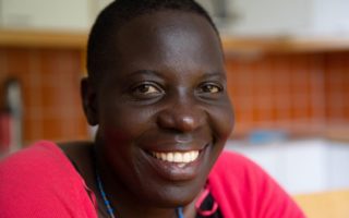 Uganda refugee smiles in new home