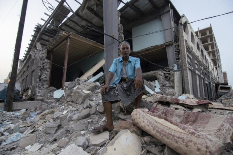 Shaker Ali sits in front of what used to be a marketplace in Aden, Yemen